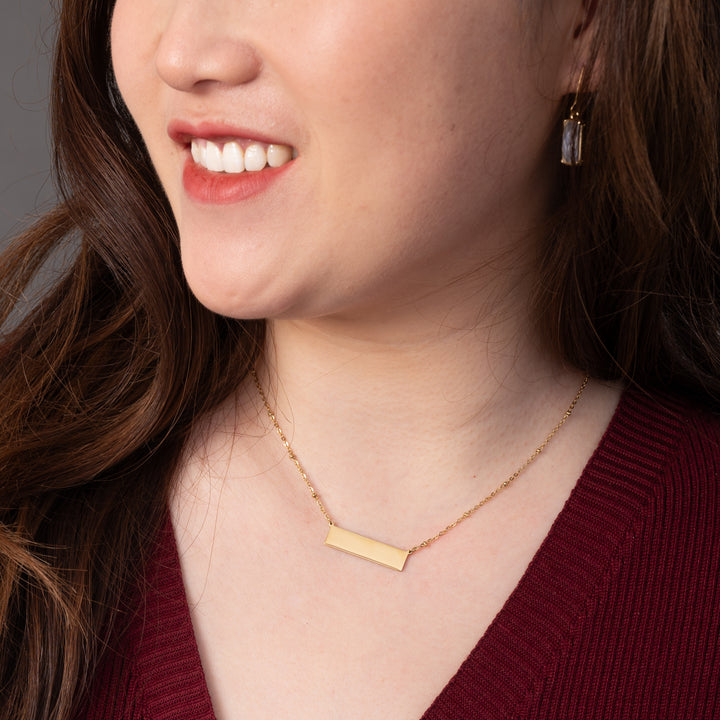 Woman wearing engravable necklace, necklaces with a message, jewelry website, gold bar necklace for women