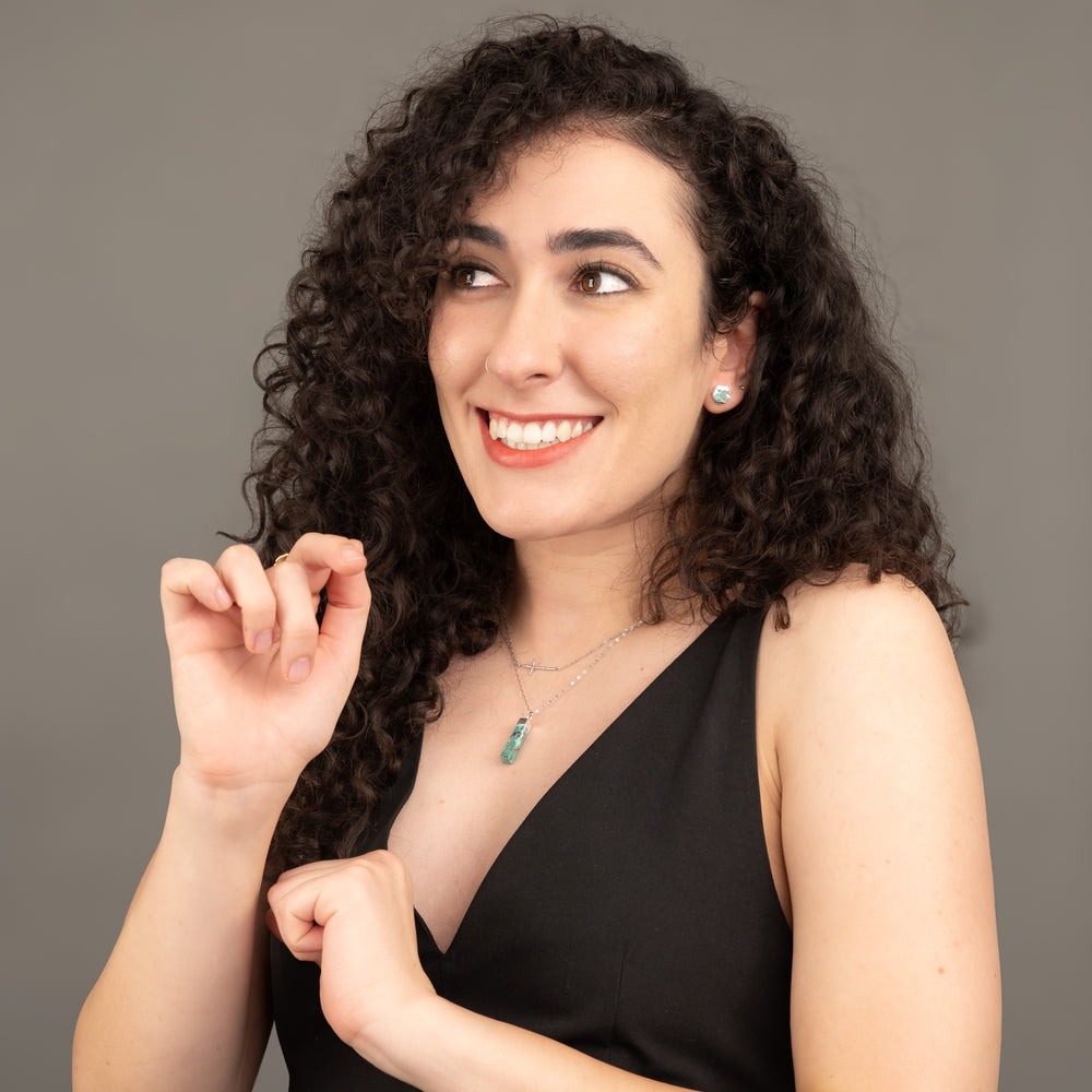 Woman wearing silver cross necklaces paired with turquoise and silver jewelry, layered silver necklaces, jewelry stores online