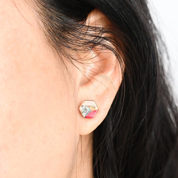 A woman wearing a colorful hexagon earring, best fair trade women's jewelry, natural stone stud, jewelry like pandora