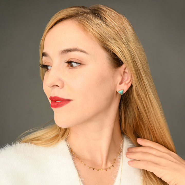 A woman wearing beautiful cute women's jewelry, 14k gold and turquoise earrings, fair trade gold jewelry, jewelry for women, jewelry presents
