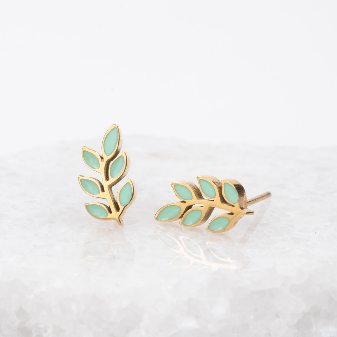 Photo of leaf-shaped earrings, mint green studs, gold and mint earrings, simplistic studs, sustainable fair trade jewelry business