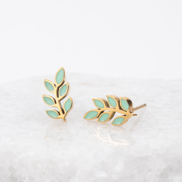 Photo of leaf-shaped earrings, mint green studs, gold and mint earrings, simplistic studs, sustainable fair trade jewelry business