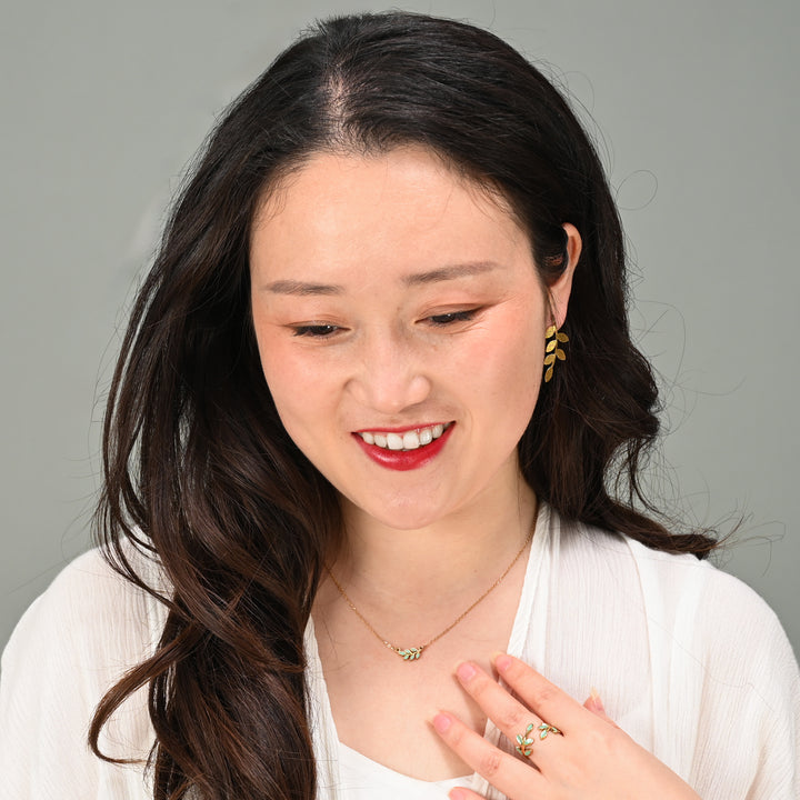 Woman modeling leaf-shaped jewelry set, matching gold and mint jewelry sets, creative gift ideas for Christmas