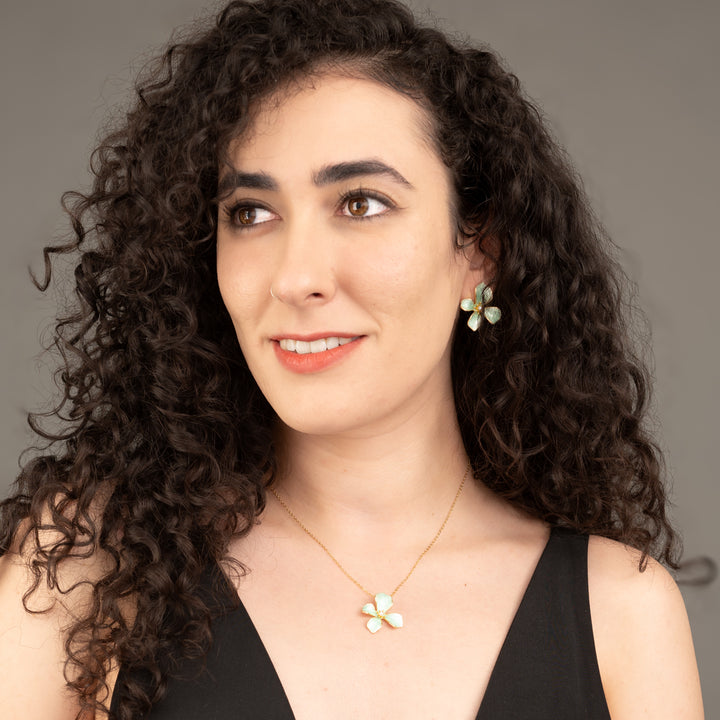 A model wearing matching floral earrings and necklace, matching flower jewelry sets, women's freedom jewelry business