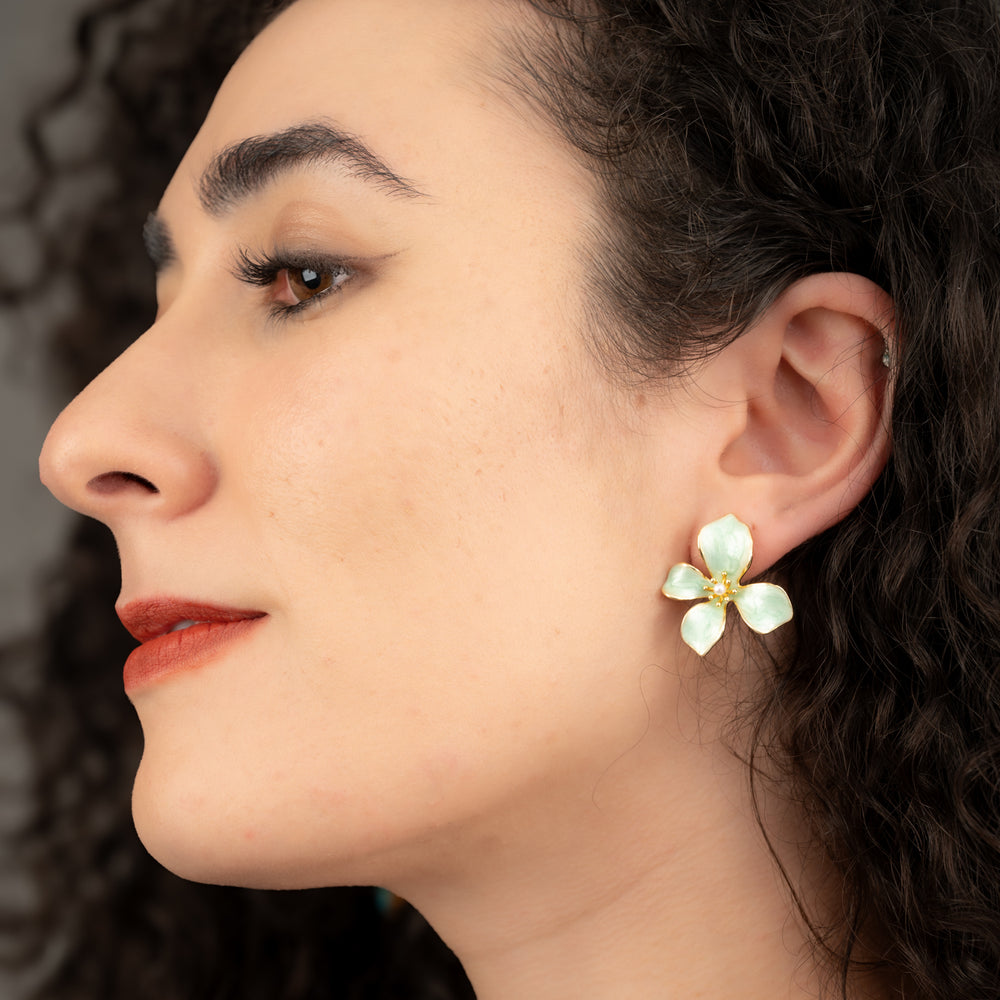 A woman earring a stunning flower earring, floral earrings, gold earrings, women's fair trade company