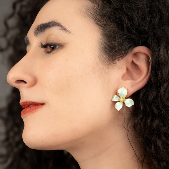 A woman earring a stunning flower earring, floral earrings, gold earrings, women's fair trade company