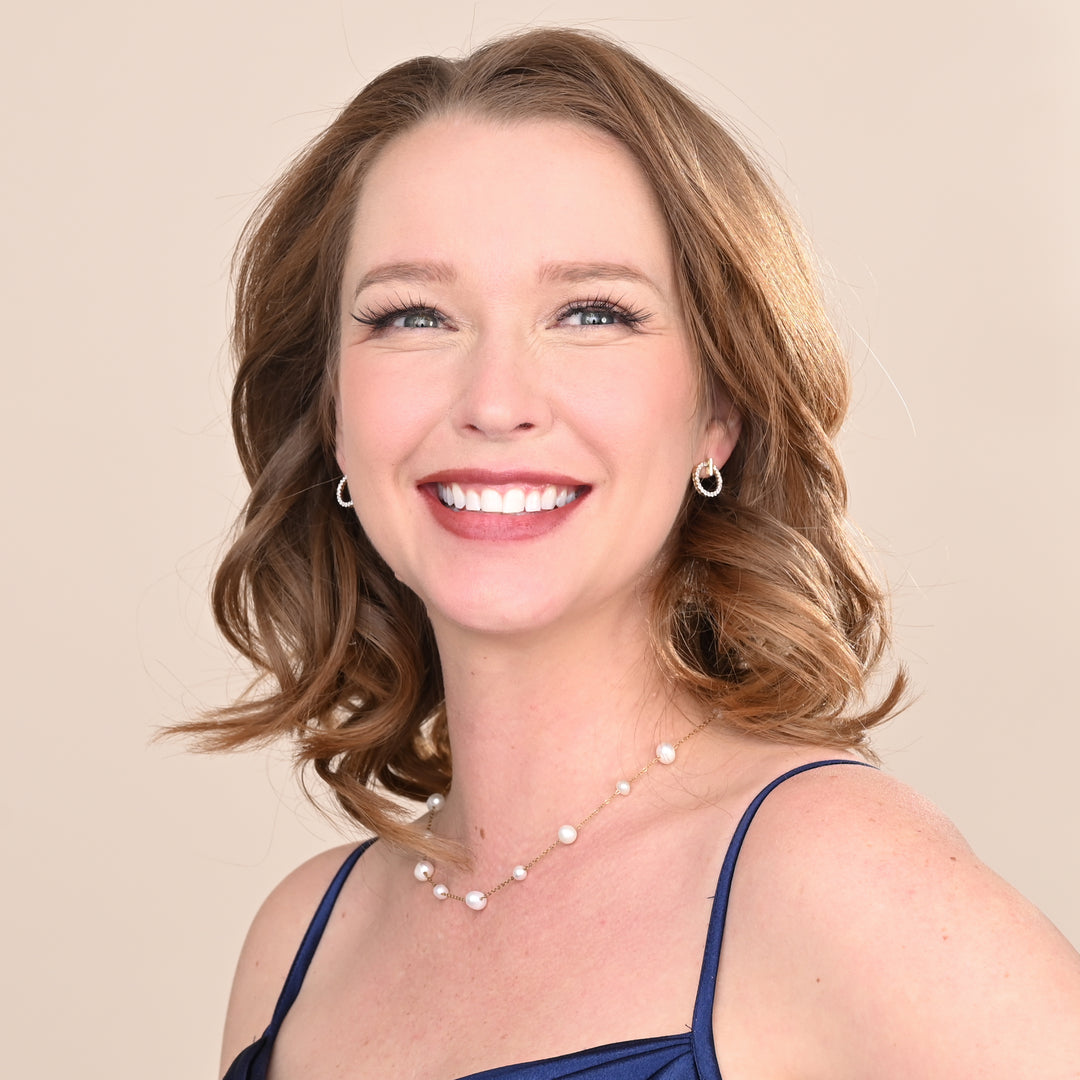 A photo of a woman wearing beautiful wedding jewelry set, gold and pearl jewelry, special christmas presents