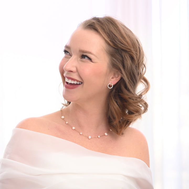 A woman on her wedding day wearing wedding necklace and earrings, jewelry for women, jewelry for weddings