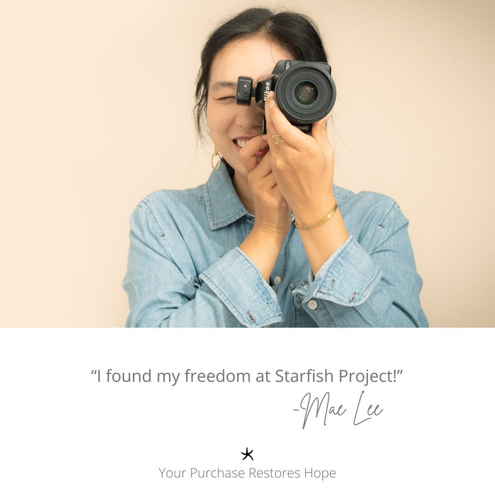 Photo of a photographer, woman holding a camera, symbol of starfish, career development, handcrafted jewelry, quality jewelry