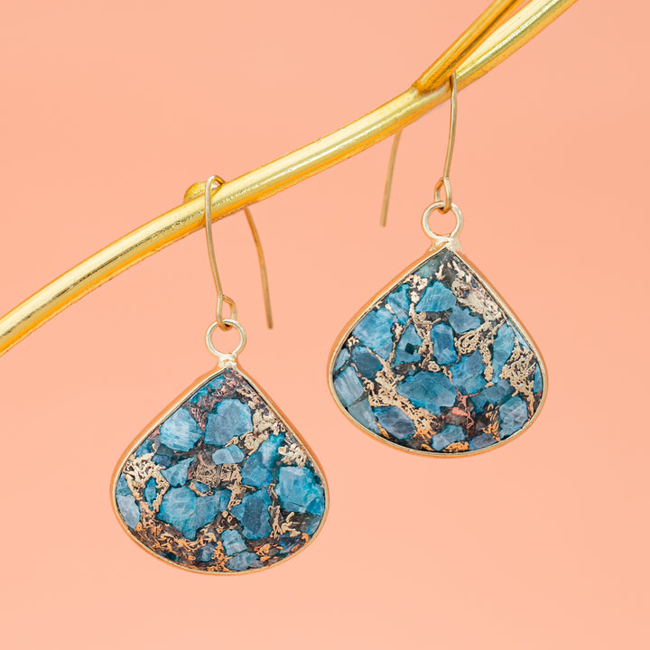 Pair of gold and blue dangling earrings hanging from gold branch, 14k gold plated stainless steel hooks, shades of gold and blue stone, sustainable fair trade jewelry, gift shops near me