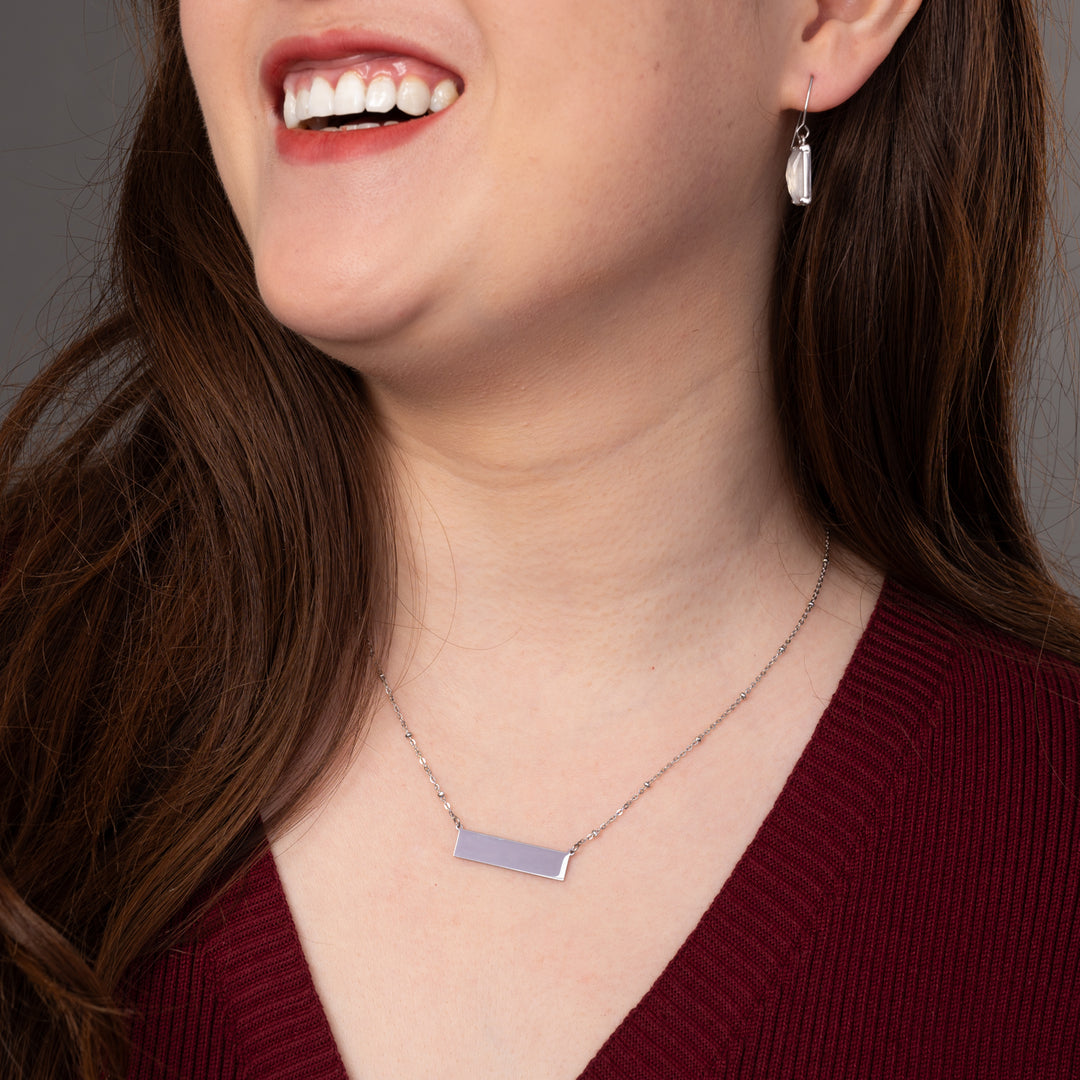 Woman wearing engravable necklace, necklaces with a message, jewelry website, silver bar necklace for women