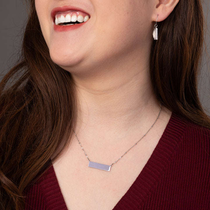 Woman wearing engravable necklace, necklaces with a message, jewelry website, silver bar necklace for women