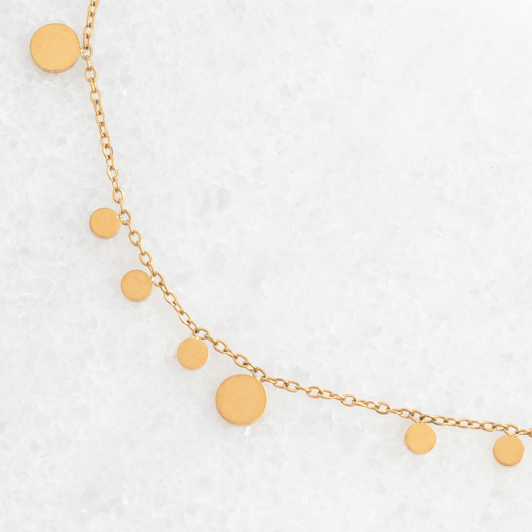 Photo of gold necklace, confetti shaped necklace, necklace for layering, golden circles, jewelry website, fair trade