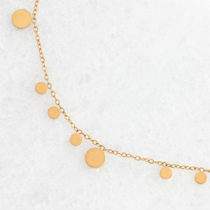 Photo of gold necklace, confetti shaped necklace, necklace for layering, golden circles, jewelry website, fair trade