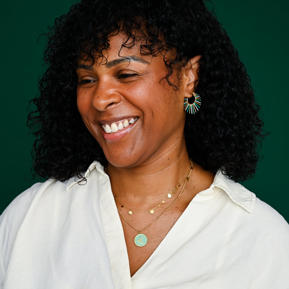 Woman wearing quality matching sets of jewelry, mint green jewelry, gold sets, sustainable fair trade jewelry