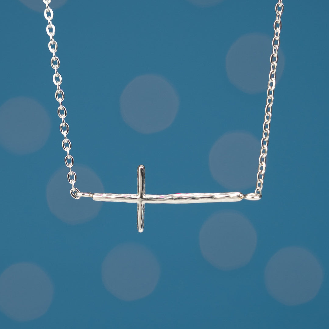 Close up photo of silver cross pendant, surprises for Christmas, gift shops near me, fair trade artisan jewelry