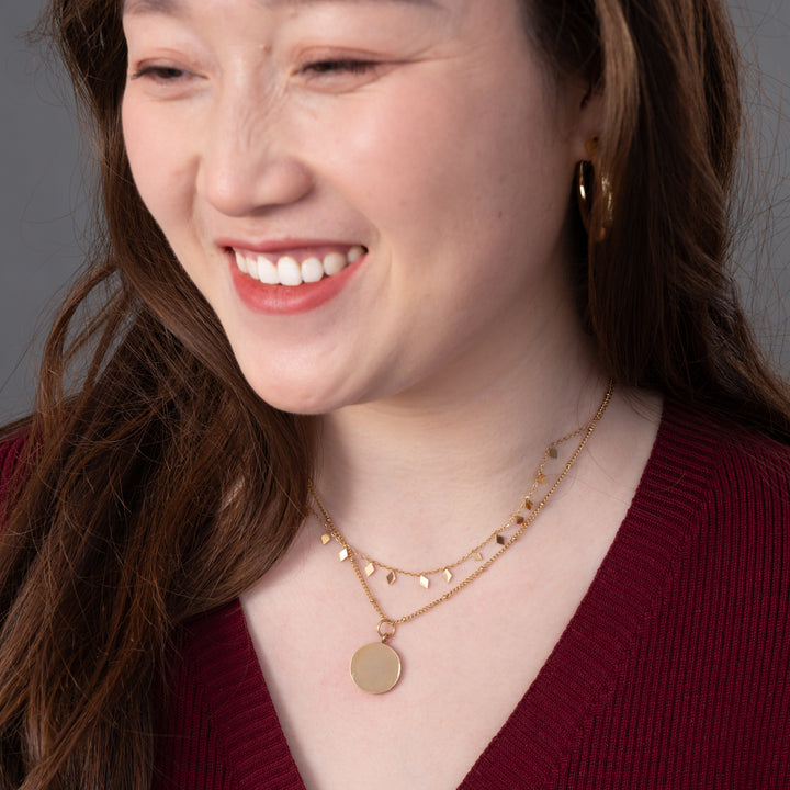 Woman wearing engravable necklace, necklaces with a message, jewelry website, layered gold necklaces