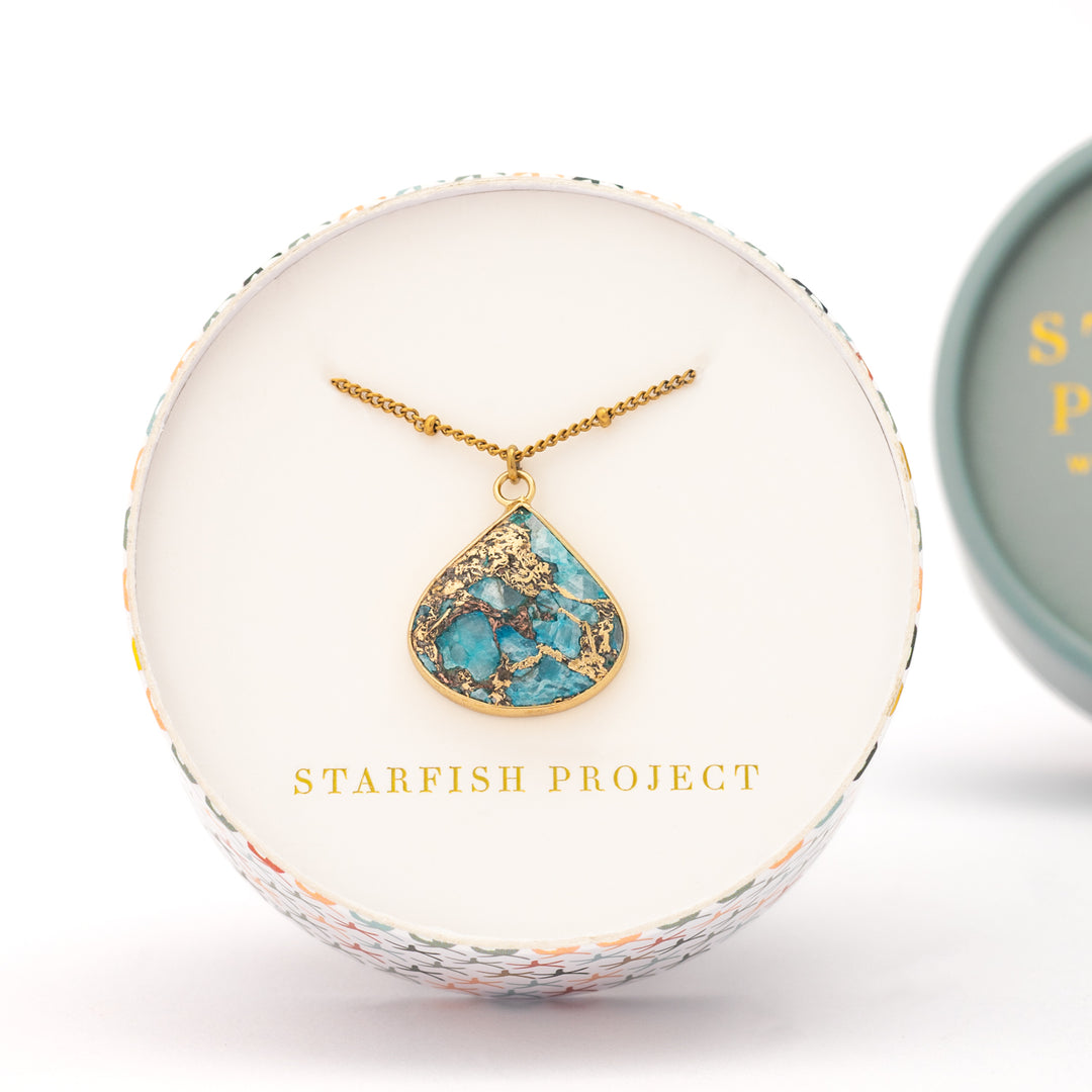 Picture of gold shaded and blue pendant, necklace, 14k gold plated stainless steel chain, jewelry gift shops, fair trade women's jewelry, white gift box, great xmas gift