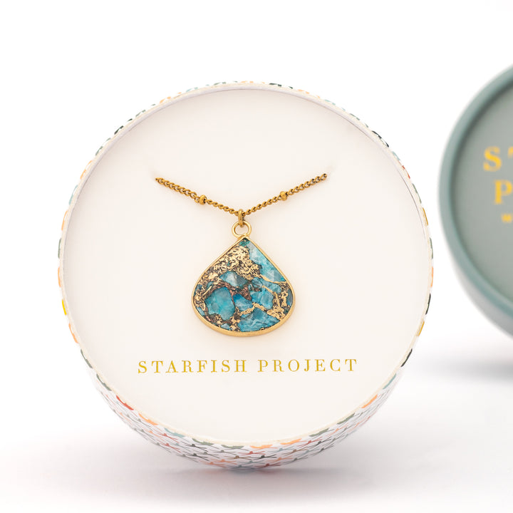 Picture of gold shaded and blue pendant, necklace, 14k gold plated stainless steel chain, jewelry gift shops, fair trade women's jewelry, white gift box, great xmas gift