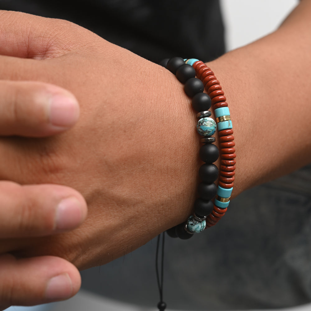 Photo of a man wearing two beaded bracelets, black beaded bracelets for men, ocean beaded bracelets for men
