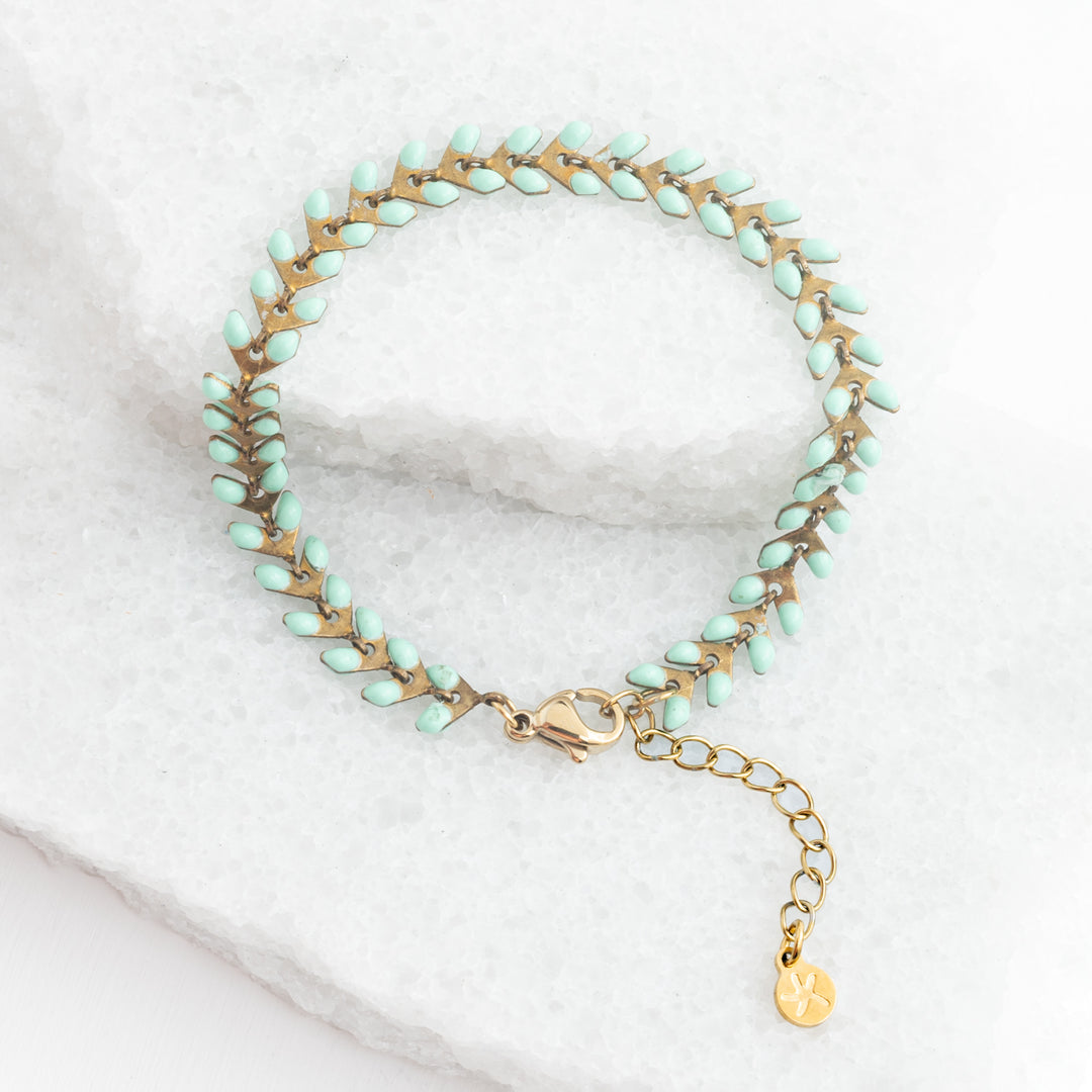 Picture of gold bracelet with mint colored seeds, seed-shaped bracelet, gold bracelets for women, sustainable fair trade jewelry