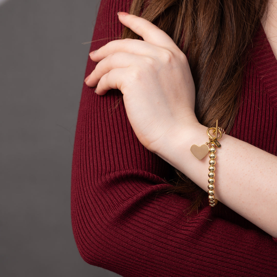 Woman wearing engraved bracelet, bracelets with a message, jewelry website, gold beads, gifting websites