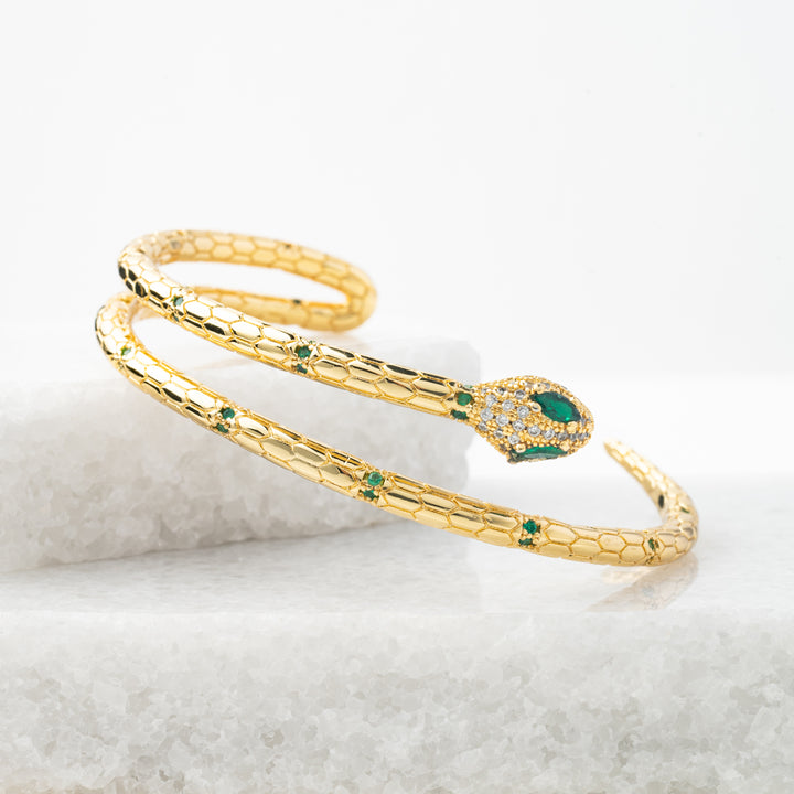 Photo of gold snake shaped bracelet, bracelet with zircon, bracelet with snake, high quality, beautiful women's jewelry, sustainable fair trade company