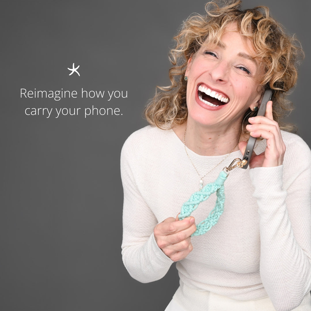 Model showing how to use hand woven phone strap, beautiful phone accessory, women's artisan jewelry business