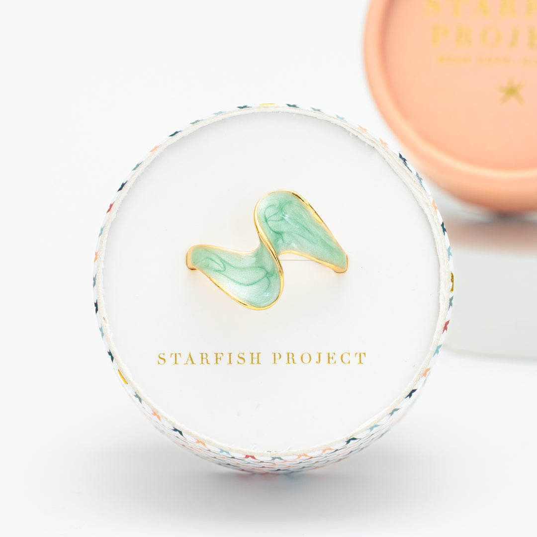 Ring box, Starfish Project website, ring with shades of green, adjustable gold rimmed ring, freedom business