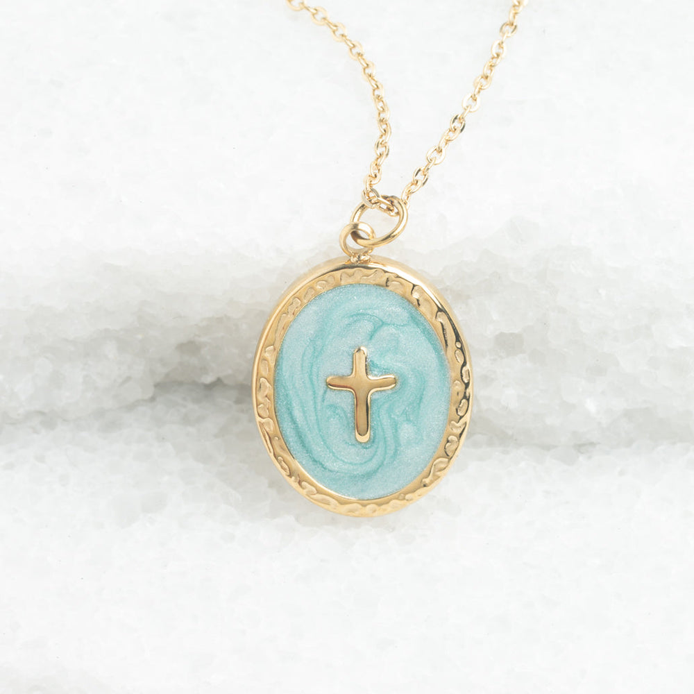 A hypoallergenic gold chain with a mint enamel pendant with a cross at the center.  Ethical jewelry perfect for gifting. 