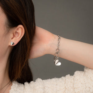 Woman wearing pearl and silver stud earrings with matching bracelet, beautiful jewelry, simplistic jewelry
