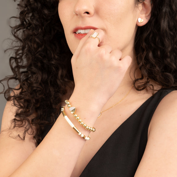 Woman wearing handcrafted gold bracelets, women's artisan jewelry, fair trade business, quality gold bracelet