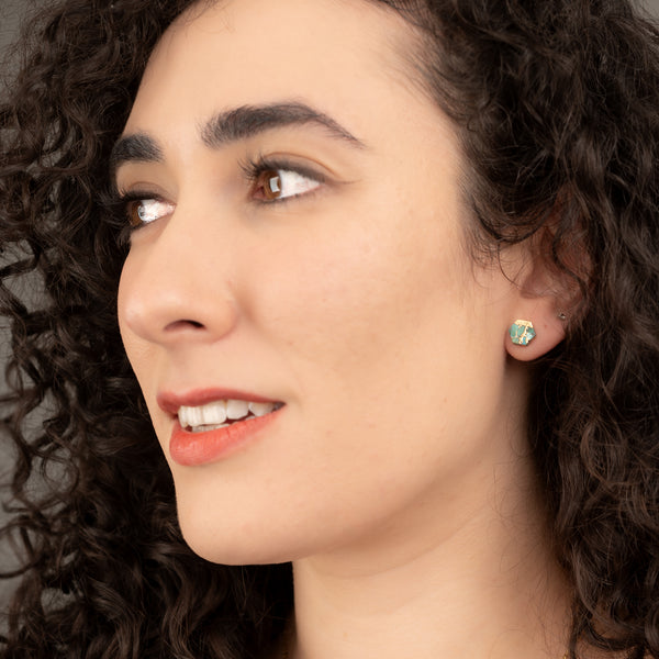 A woman wearing high quality, fashion, women's jewelry, turquoise and gold stud earrings, best presents, online jewelry Starfish Project, fair trade business