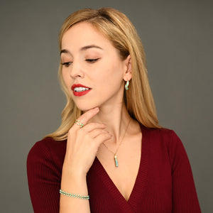 Woman wearing matching mint green and gold jewelry, gold jewelry sets, jewelry pairings, jewelry stores like pandora 