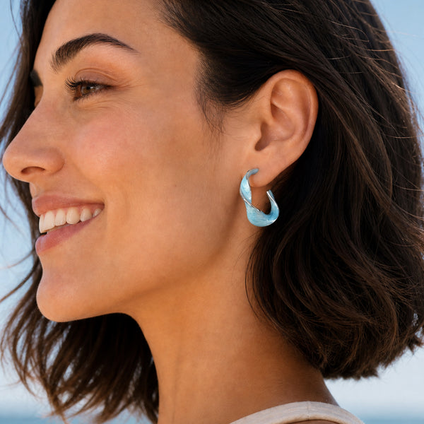 Model wearing Sky Blue With a Twist hoop earrings by Starfish Project, an ethical jewelry gift for mom or a friend.