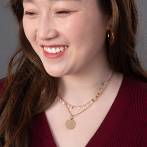 Woman wearing engravable necklace, necklaces with a message, jewelry website, layered gold necklaces