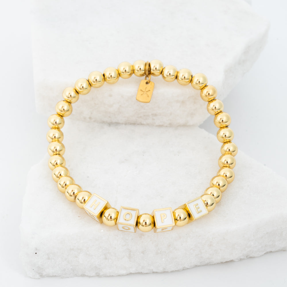 Photo of gold beaded bracelet, gold "hope" message, gold brass beads, symbol of hope, jewelry company like pandora