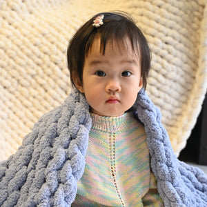A photo of a baby in beautifully hand made blanket, special mother's day present