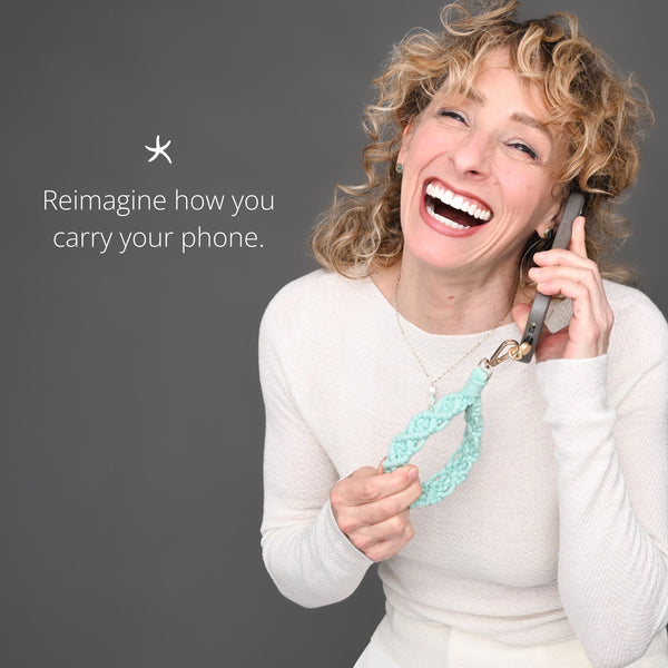 Model showing how to use hand woven phone strap, beautiful phone accessory, women's artisan jewelry business