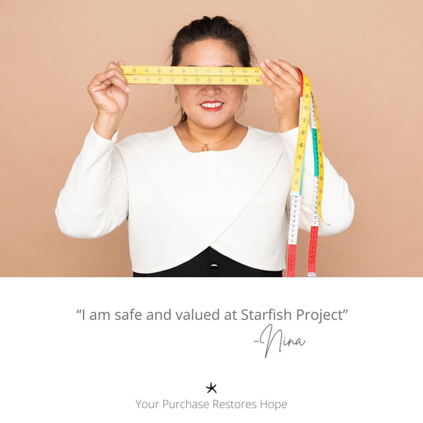 Picture of woman wearing Starfish Project pieces, handcrafted jewelry, symbol of hope, women's artisan jewelry business