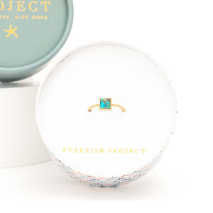 Photo of gold ring in gift box, Starfish Project gift, square gold ring, women's fair trade business