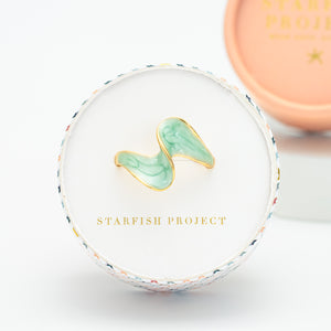 Ring box, Starfish Project website, ring with shades of green, adjustable gold rimmed ring, freedom business
