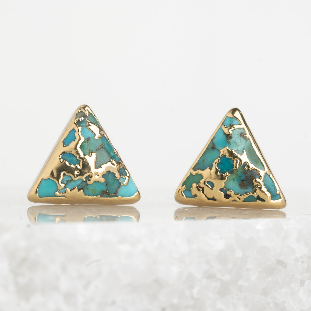 A pair of natural turquoise and 14k plated gold studs, sustainable fair trade jewelry, women's jewelry, beautiful and quality earrings set against a marble background. Great Christmas present (unique xmas gift), present for Mother's day 